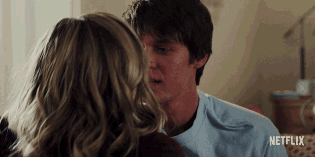 a man and a woman are kissing with a netflix logo behind them
