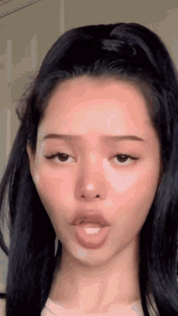 a close up of a girl 's face with her mouth open