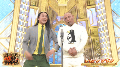 two men standing in front of a microphone with the first round written on the bottom right
