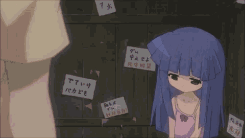 a girl in a pink tank top stands in front of a wall with a bunch of signs on it