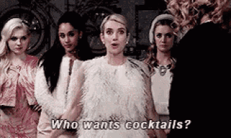a group of women are standing next to each other and one of them is asking who wants cocktails ?