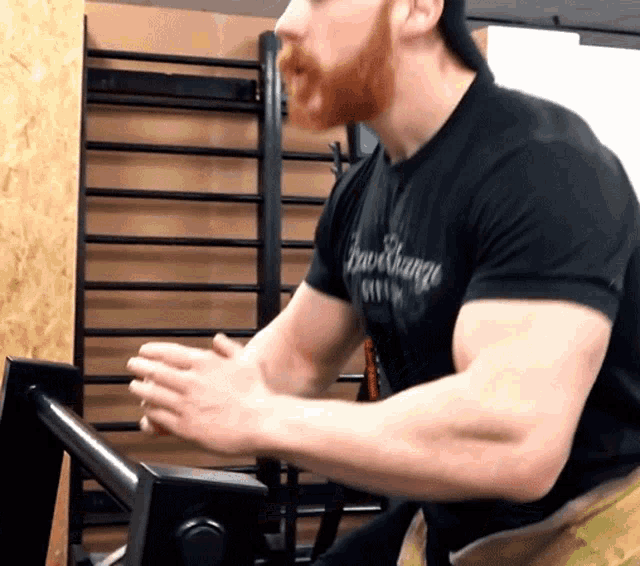 a man wearing a black shirt that says barchange