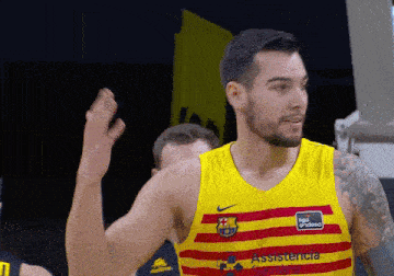 a man wearing a yellow and red striped shirt that says assistance