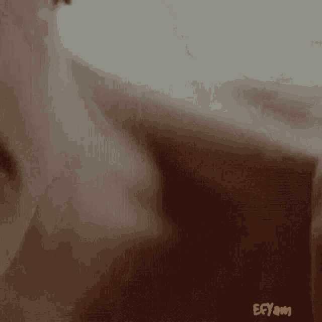 a close up of a person 's face with ecyam written on the bottom right corner