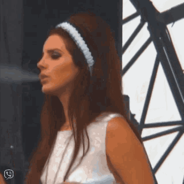 a woman with long hair wearing a white dress and a headband