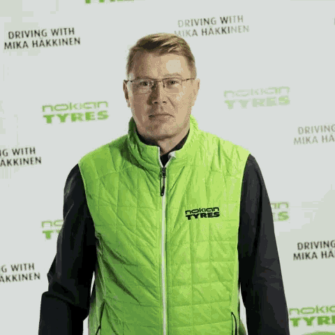 a man in a green nokian tires vest