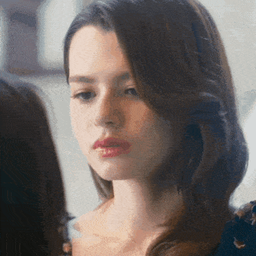 a close up of a woman 's face with red lipstick