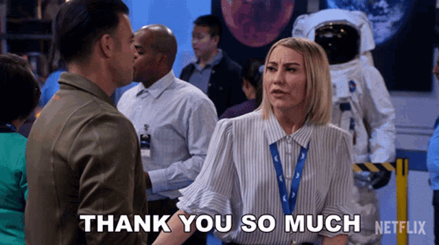 a woman in a striped shirt says " thank you so much " in front of an astronaut