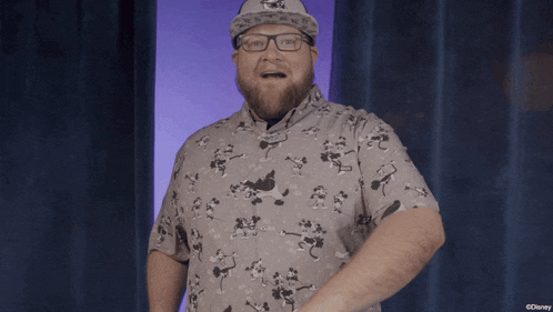 a man wearing glasses and a hat with a mickey mouse logo on it
