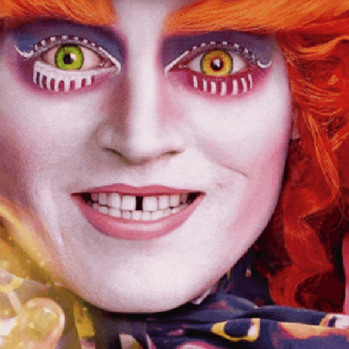 a close up of a person 's face with red hair and green and yellow eyes