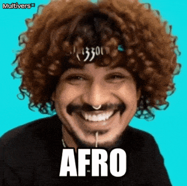 a man with curly hair and a beard is smiling and the word afro is on the screen .