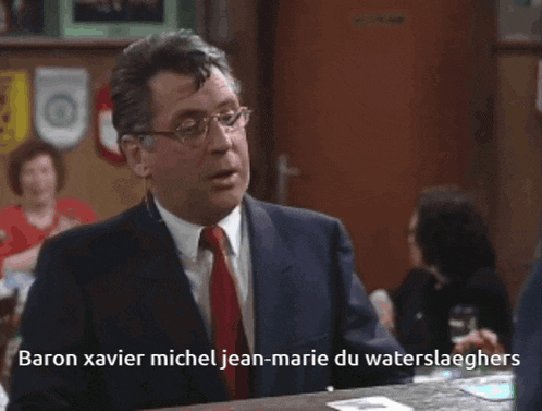 a man in a suit and tie says baron xavier michel jean-marie du waterslaghers
