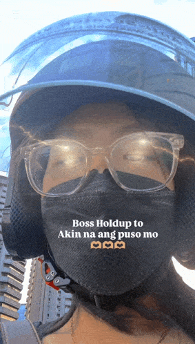 a woman wearing a mask and a helmet says boss hold up to akin na ang puso mo
