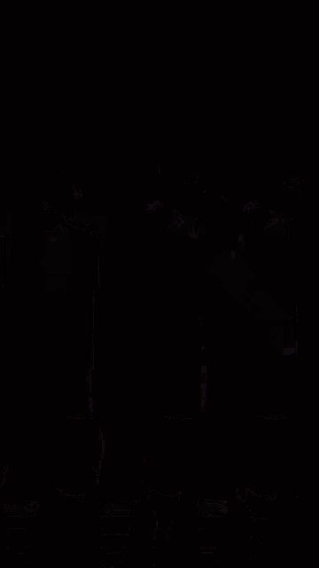 three people wearing black shirts and socks are dancing together