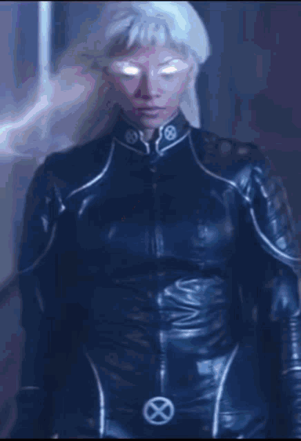 a woman in a x-men costume is standing in a dark hallway