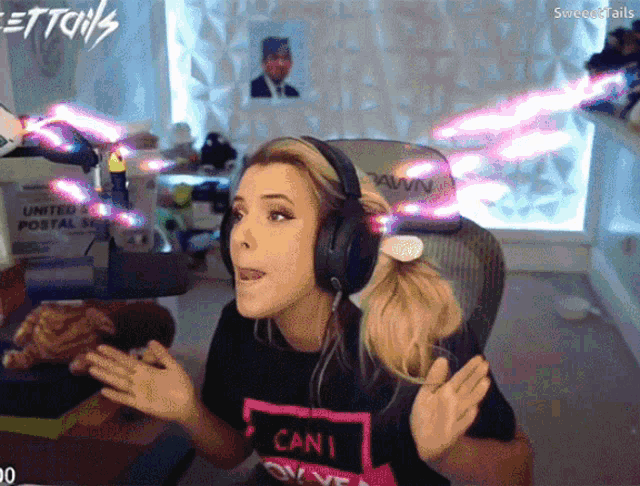 a woman wearing headphones and a shirt that says " can i live "