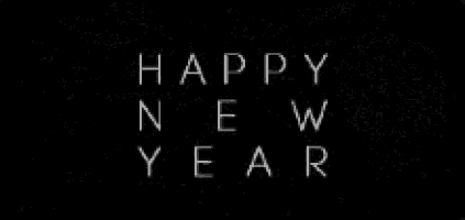a black and white photo of fireworks with the words `` happy new year '' written in white letters .