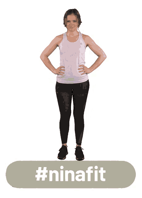a woman in a purple tank top stands with her hands on her hips