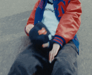 a person wearing a red and blue jacket with the letter n on the sleeves