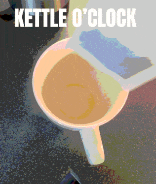 a cup of coffee sits on a table with the words kettle o 'clock written above it