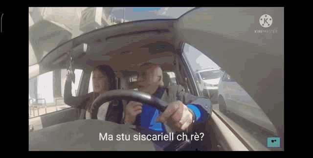 a man is driving a car with a woman behind him and the words ma stu siscariell ch re written on the dashboard
