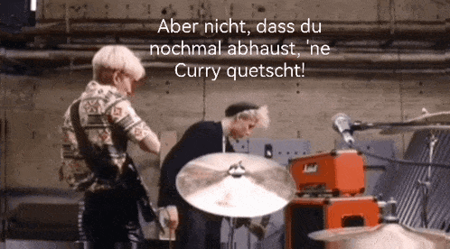 two men are playing drums in a room with the words aber nicht dass du nochmal abhaust ne curry quetscht