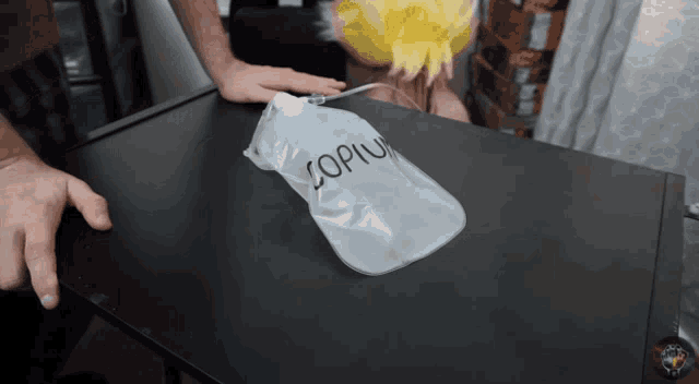 a person is holding a plastic bag that says copium on it