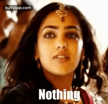 a close up of a woman 's face with the words `` nothing '' written on her face .