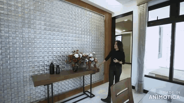 a woman is standing in a room with a made in animatica watermark