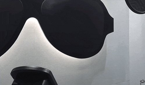 a close up of a pair of sunglasses on a white surface