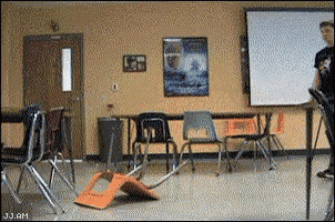 a classroom with chairs and a projector screen with jj.am written on the bottom left
