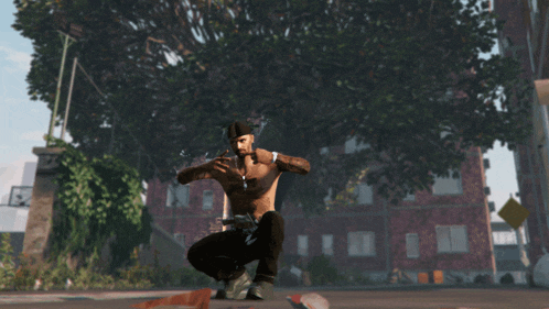 a man without a shirt is squatting down in front of a tree