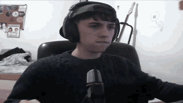 a man wearing headphones looks at the camera