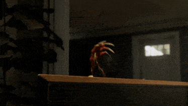 a monster is crawling out of a book on a desk