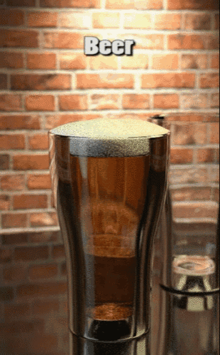 a glass of beer with a brick wall in the background