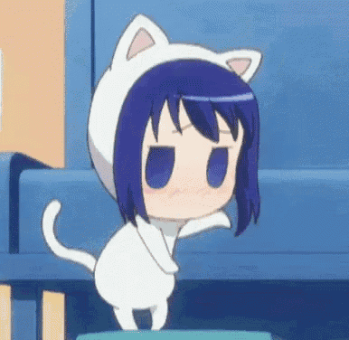a little girl with blue hair is wearing a cat costume and standing on a table .