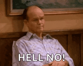 a man is sitting in a chair with his arms crossed and says `` hell no '' .