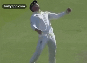 a man in a white shirt is dancing on a field .