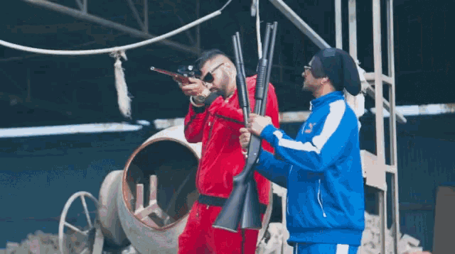 a man in a red suit and a man in a blue jacket holding guns