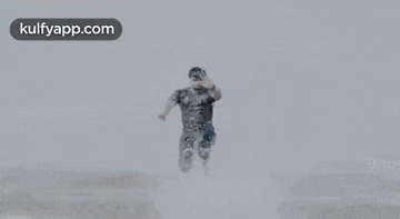 a man in a military uniform is flying through the air in a video .