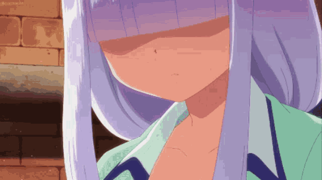 a close up of a girl 's face with a brick wall in the background