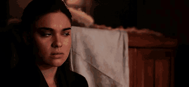a close up of a woman 's face with a tear running down her face .