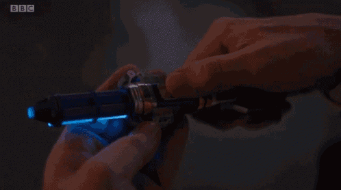 a person is holding a glow in the dark object with bbc written on the bottom right