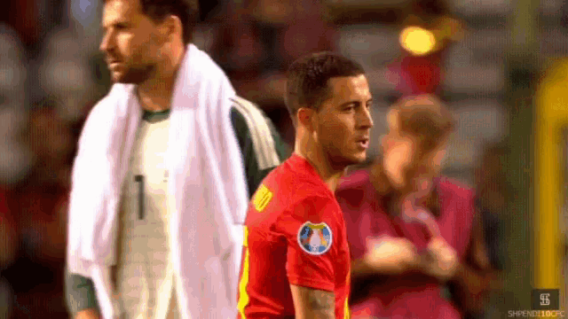 a soccer player wearing a red jersey with the number 10 on it