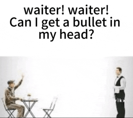a waiter is standing next to a man sitting at a table with his hand in the air .