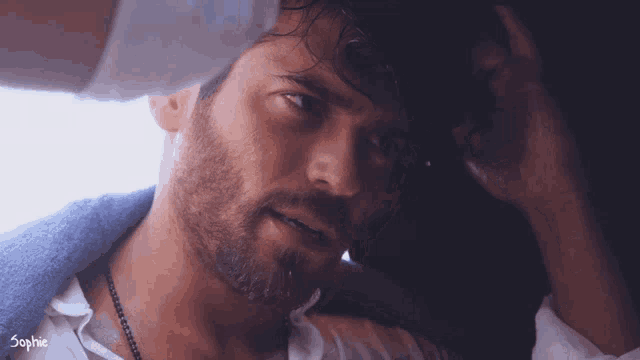 a close up of a man 's face with sophie written on the bottom right