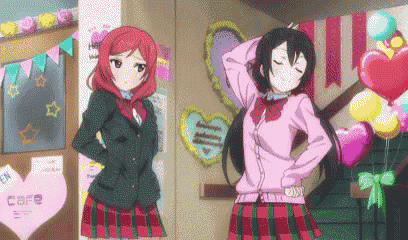 a couple of anime girls standing next to each other in a room