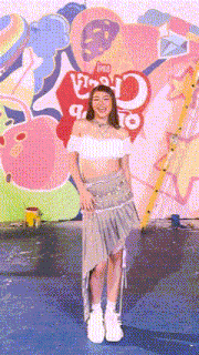 a woman stands in front of a wall that has a sign that says ' candy ' on it