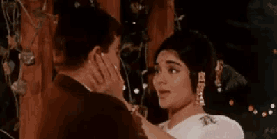 a man and a woman are kissing with a caption in a foreign language .