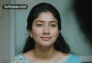 a close up of a woman 's face with the words kulfyapp.com visible